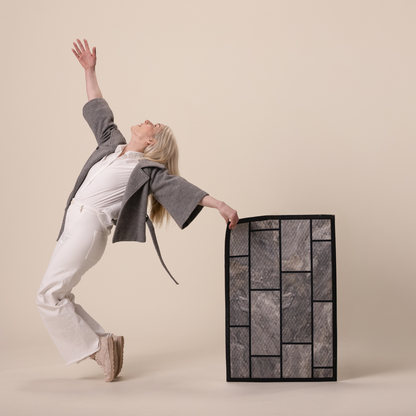 person holding a stone looking door mat 